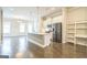 An open kitchen features an island, stainless appliances, and bright airy views creating a modern and inviting atmosphere at 1106 Bakary Ct, Decatur, GA 30032