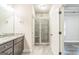 Large primary bathroom with granite counters, gray cabinets, and a walk-in shower at 1106 Bakary Ct, Decatur, GA 30032