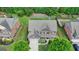 Aerial shot of a brick and siding home with well-maintained landscaping and a driveway at 1370 Sunnys Halo Dr, Suwanee, GA 30024