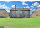 Rear view of a home with large yard and many windows for natural light at 1370 Sunnys Halo Dr, Suwanee, GA 30024