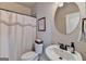 Cozy bathroom featuring a vanity sink, toilet, and tub with a shower curtain at 1370 Sunnys Halo Dr, Suwanee, GA 30024