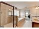 Bathroom features a walk-in shower, soaking tub, tile accents, and adjacent bedroom at 1370 Sunnys Halo Dr, Suwanee, GA 30024