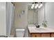 Bathroom featuring neutral walls, a white shower curtain and a vanity sink with mirror at 1370 Sunnys Halo Dr, Suwanee, GA 30024