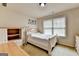 Bedroom with light-colored walls, carpeted floor, and a large window for natural light at 1370 Sunnys Halo Dr, Suwanee, GA 30024