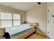 Bedroom featuring neutral walls and carpet, window for natural light, and minimalist wooden bed frame at 1370 Sunnys Halo Dr, Suwanee, GA 30024