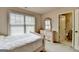 Bright bedroom with a light-colored dresser, a large window and en suite bathroom at 1370 Sunnys Halo Dr, Suwanee, GA 30024