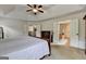 Bedroom with neutral carpet and white doors leading to closets and other rooms at 1370 Sunnys Halo Dr, Suwanee, GA 30024