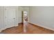 Spacious empty bedroom with hardwood floors and two closets near the entry door at 1370 Sunnys Halo Dr, Suwanee, GA 30024