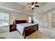 Spacious bedroom with neutral color palette, ceiling fan, and carpeted floor offers comfort and style at 1370 Sunnys Halo Dr, Suwanee, GA 30024