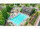 Aerial view of the community pool, clubhouse, and playground, perfect for Gathering fun and relaxation at 1370 Sunnys Halo Dr, Suwanee, GA 30024