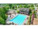 Community pool with clean, inviting waters, surrounded by lounge chairs and beautiful landscaping in a Gathering neighborhood at 1370 Sunnys Halo Dr, Suwanee, GA 30024