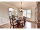Dining room with hardwood floors and wainscoting is adjacent to the foyer at 1370 Sunnys Halo Dr, Suwanee, GA 30024
