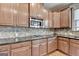 Modern kitchen with wood cabinets and granite countertops at 1370 Sunnys Halo Dr, Suwanee, GA 30024