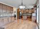 Spacious kitchen features wood cabinets, granite countertops, and island at 1370 Sunnys Halo Dr, Suwanee, GA 30024