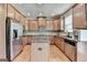 Kitchen features stainless steel appliances, wood cabinets, and island at 1370 Sunnys Halo Dr, Suwanee, GA 30024