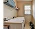 Bright laundry room with a front load washer and dryer, plus wire shelving at 1370 Sunnys Halo Dr, Suwanee, GA 30024