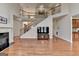 Open-concept living space with fireplace, staircase, and hardwood floors at 1370 Sunnys Halo Dr, Suwanee, GA 30024