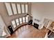 Living room with a fireplace, large windows, hardwood floors, and a ceiling fan at 1370 Sunnys Halo Dr, Suwanee, GA 30024