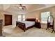 Main bedroom with vaulted ceiling, two windows, a ceiling fan, and carpet at 1370 Sunnys Halo Dr, Suwanee, GA 30024