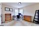 Well-lit home office with neutral walls, two windows, and practical furniture at 1370 Sunnys Halo Dr, Suwanee, GA 30024