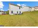 Backyard with a sloped lawn, exterior of home, gas grill, and lush green grass at 1003 Nandina Ct, Villa Rica, GA 30180