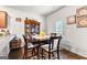 Cozy dining room features a dark wood table and chairs, cabinet, and decor at 1003 Nandina Ct, Villa Rica, GA 30180