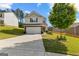 Charming two-story home featuring a well-maintained lawn and a spacious two car garage at 1003 Nandina Ct, Villa Rica, GA 30180