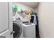 Convenient laundry room with modern washer and dryer, shelf, and ample storage space at 1003 Nandina Ct, Villa Rica, GA 30180