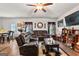 Comfortable open concept living space features wood flooring, ceiling fan and comfortable seating at 1003 Nandina Ct, Villa Rica, GA 30180