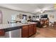 Open-concept living room with a leather sectional and seamless flow from the kitchen at 1003 Nandina Ct, Villa Rica, GA 30180