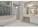 Well-lit bathroom featuring a large tub, separate glass enclosed shower, and a vanity area at 229 Terrane Rdg, Peachtree City, GA 30269