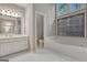 Bright bathroom with a large tub, separate glass enclosed shower, and vanity at 229 Terrane Rdg, Peachtree City, GA 30269