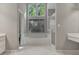 Bright bathroom featuring a large tub, separate glass enclosed shower, and dual sink vanities at 229 Terrane Rdg, Peachtree City, GA 30269