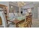 Elegant dining room features a chandelier, set table, and views of the living area at 229 Terrane Rdg, Peachtree City, GA 30269