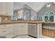 Open kitchen with granite counters, stainless dishwasher, and view to the living room at 229 Terrane Rdg, Peachtree City, GA 30269