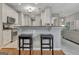 Modern kitchen with white cabinets, stainless steel appliances, and breakfast bar with seating at 229 Terrane Rdg, Peachtree City, GA 30269