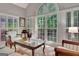 Sunlit living room featuring hardwood floors, plantation shutters, and charming decor at 229 Terrane Rdg, Peachtree City, GA 30269