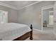 Neutral-toned main bedroom with carpet flooring, tray ceiling, and doorway leading to the living room at 229 Terrane Rdg, Peachtree City, GA 30269