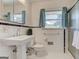 Bathroom with tiled shower and pedestal sink at 2942 Old Norcross Rd, Tucker, GA 30084