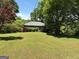 Sprawling front lawn and landscaped greenery highlight this charming single-story home at 2942 Old Norcross Rd, Tucker, GA 30084