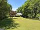 Expansive front yard with mature trees and a well-maintained lawn enhances curb appeal at 2942 Old Norcross Rd, Tucker, GA 30084