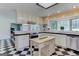 Updated kitchen with checkerboard tile flooring and stainless appliances at 2942 Old Norcross Rd, Tucker, GA 30084