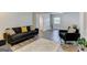 Inviting living room with modern furnishings, light wood floors, and ample natural light at 2942 Old Norcross Rd, Tucker, GA 30084