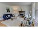 Inviting living room featuring a cozy fireplace, stylish furnishings, and ample natural light at 2942 Old Norcross Rd, Tucker, GA 30084