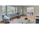 Bright living room with hardwood floors, decorative seating, and access to the dining area at 2942 Old Norcross Rd, Tucker, GA 30084