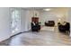 Comfortable living room with brick fireplace, light wood floors, and glass patio doors at 2942 Old Norcross Rd, Tucker, GA 30084