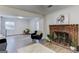 Spacious living room with brick fireplace, light wood floors, and an open layout at 2942 Old Norcross Rd, Tucker, GA 30084