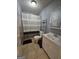 Small bathroom with neutral tile, vanity, toilet and shower with striped curtain and decorative wall hangings at 220 Jackson Rd, Mcdonough, GA 30252