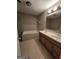 Bathroom featuring double sinks, tile floors, a tub, and neutral walls at 220 Jackson Rd, Mcdonough, GA 30252