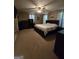 Spacious main bedroom with plush carpet, a ceiling fan, and natural light at 220 Jackson Rd, Mcdonough, GA 30252
